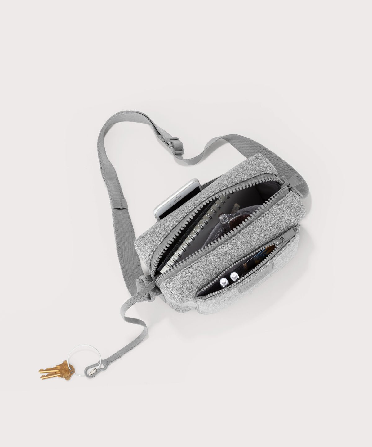 Dagne Dover Micah Crossbody in grey seen from above, showing the interior air mesh pocket.