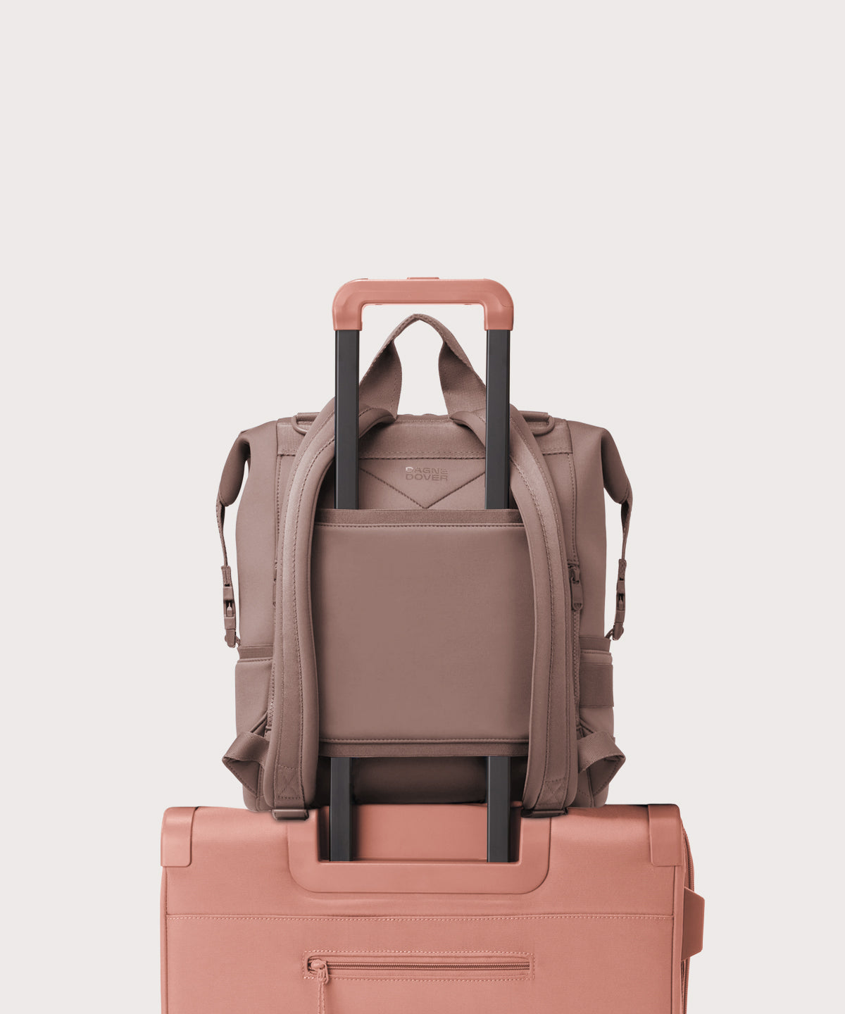 Dagne Dover Large Indi Diaper Backpack in pink showing the neoprene luggage sleeve.
