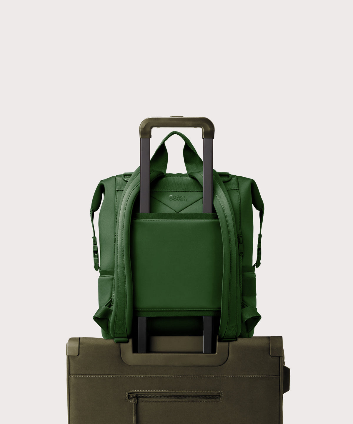 Dagne Dover Large Indi Diaper Backpack in a rich, classic forest green showing the neoprene luggage sleeve.
