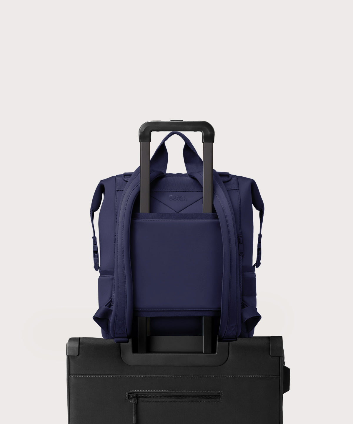 Dagne Dover Large Indi Diaper Backpack in dark blue showing the neoprene luggage sleeve.

