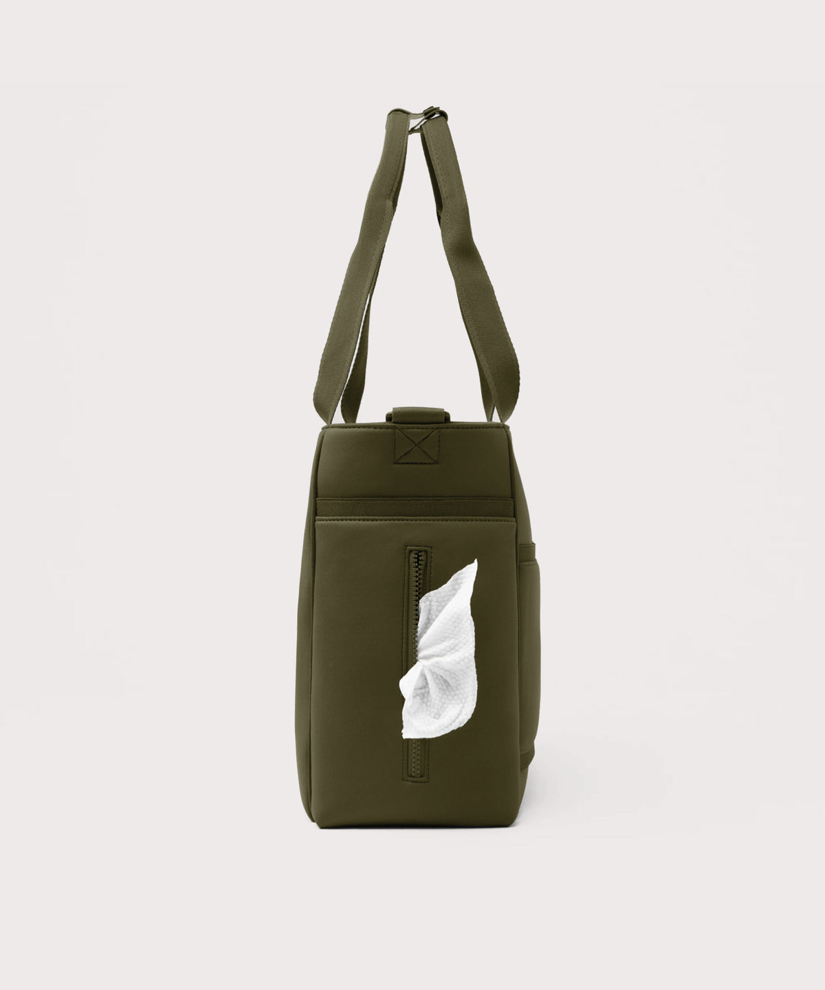Dagne Dover large Wade Diaper Tote in dark green seen from the side, with a wet wipe poking out of the slip pocket.

