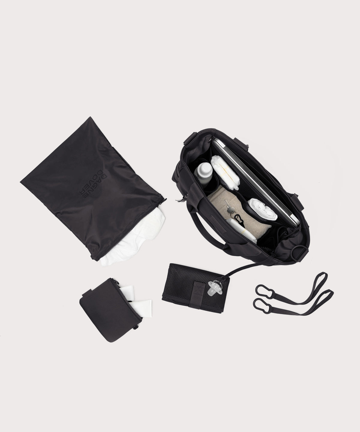 Dagne Dover large Wade Diaper Tote in black seen from above, alongside the changing mat, neoprene pouch, and water resistant zipper bag.