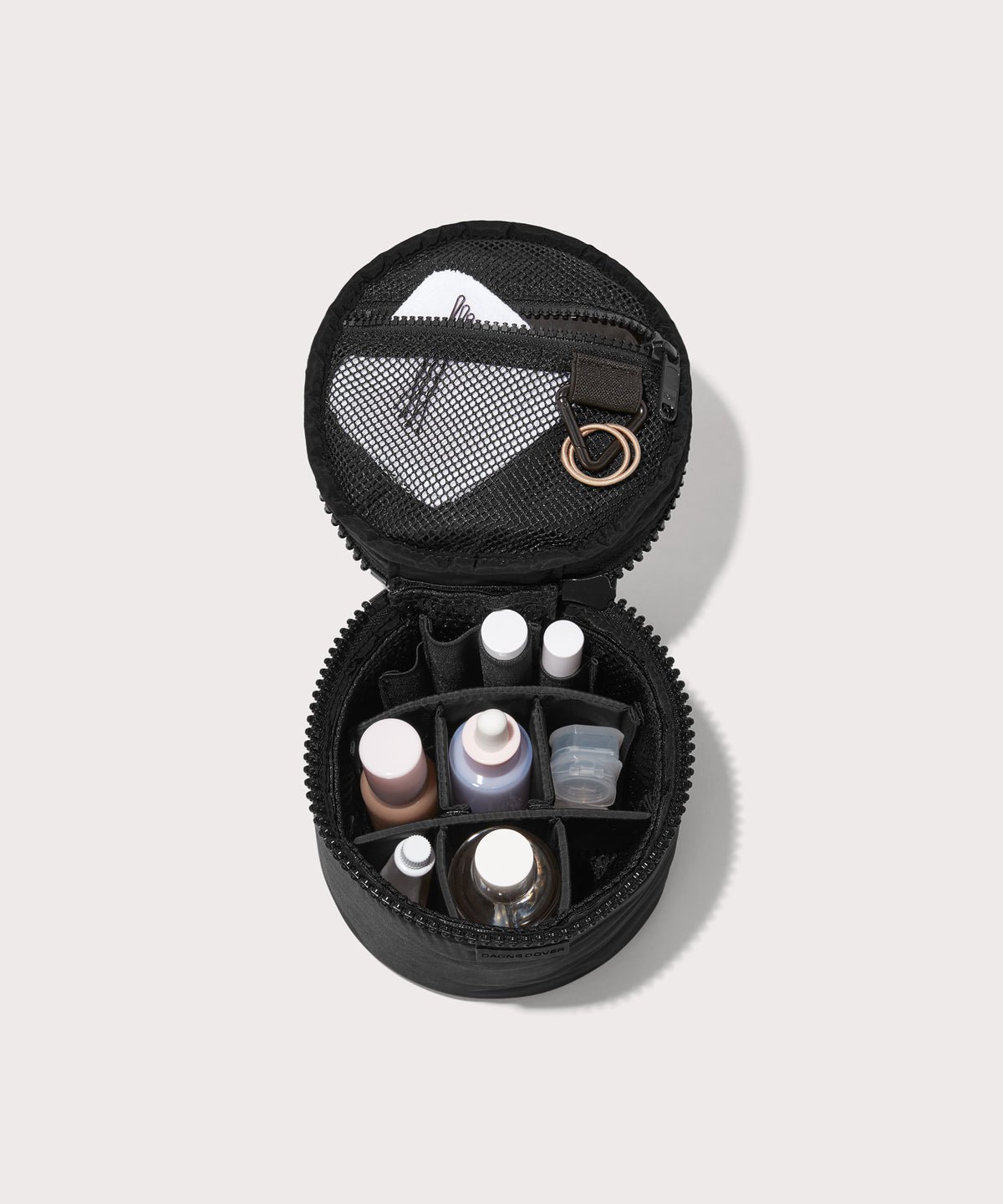 Dagne Dover small Mila Toiletry Pouch in black unzipped filled with toiletry products.