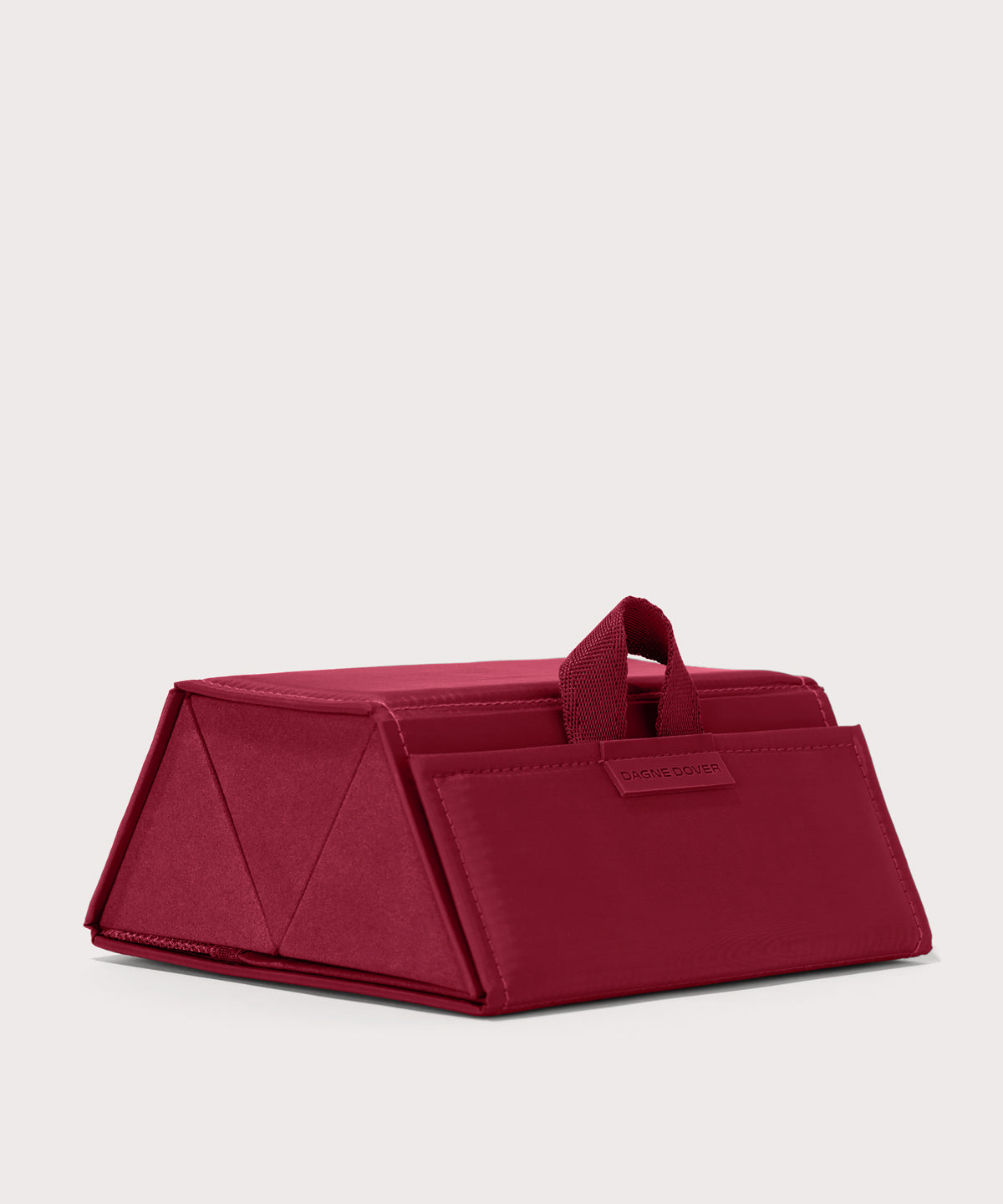 Dagne Dover Remi foldable glasses holder in spice red seen from an angle.
