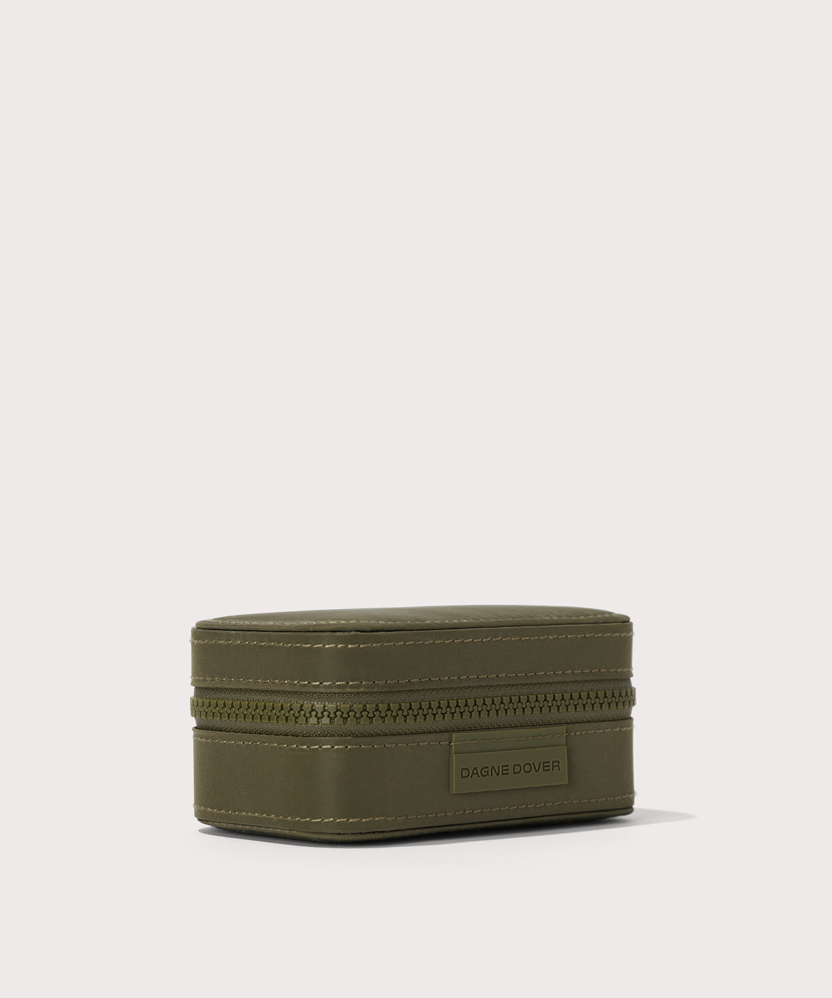 Dagne Dover small Frankie Jewelry Case in dark green seen from an angle.

