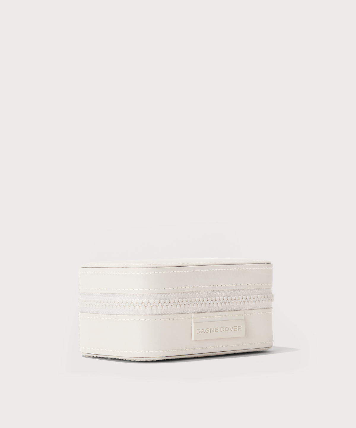 Dagne Dover small Frankie Jewelry Case in white seen from an angle.
