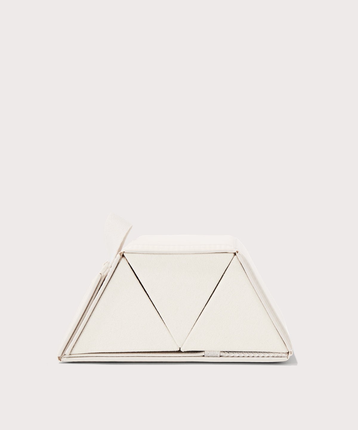 Dagne Dover Remi foldable glasses holder in white seen from the side.
