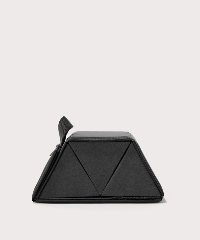 Dagne Dover Remi foldable glasses holder in black seen from the side.
