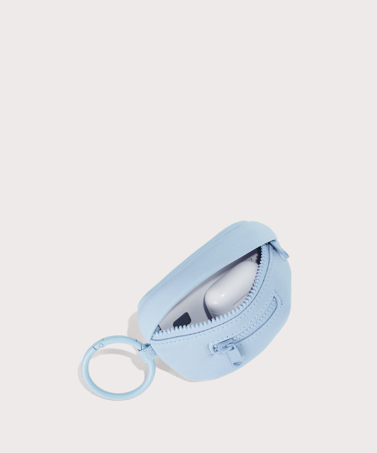 Dagne Dover Ace Keychain in an airy, lighter sky blue. unzipped, showing interior.
