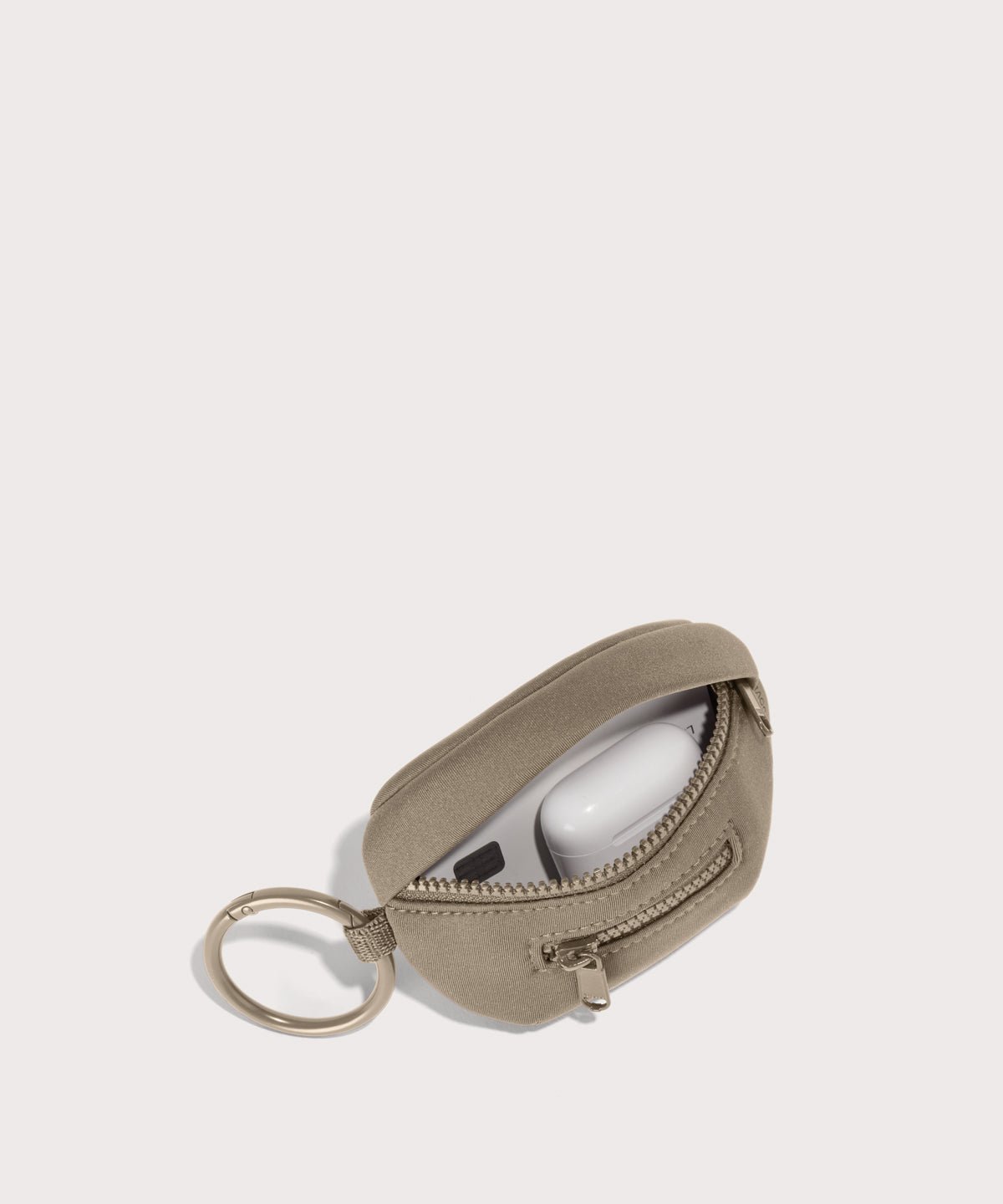 Dagne Dover Ace Keychain in a medium-dark, creamy tan unzipped, showing interior.
