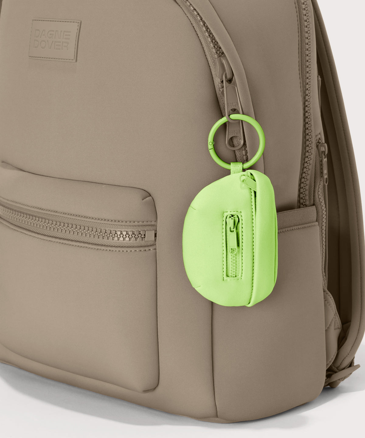 Dagne Dover Ace Keychain in vibrant, creamy green clipped onto a backpack. hover