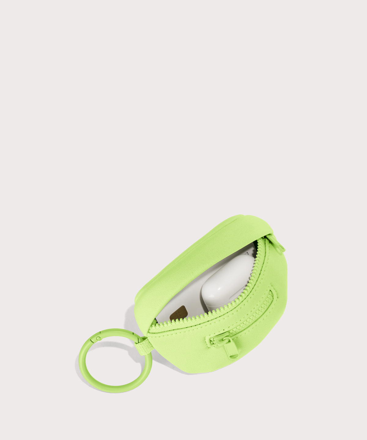 Dagne Dover Ace Keychain in vibrant, creamy green unzipped, showing interior.
