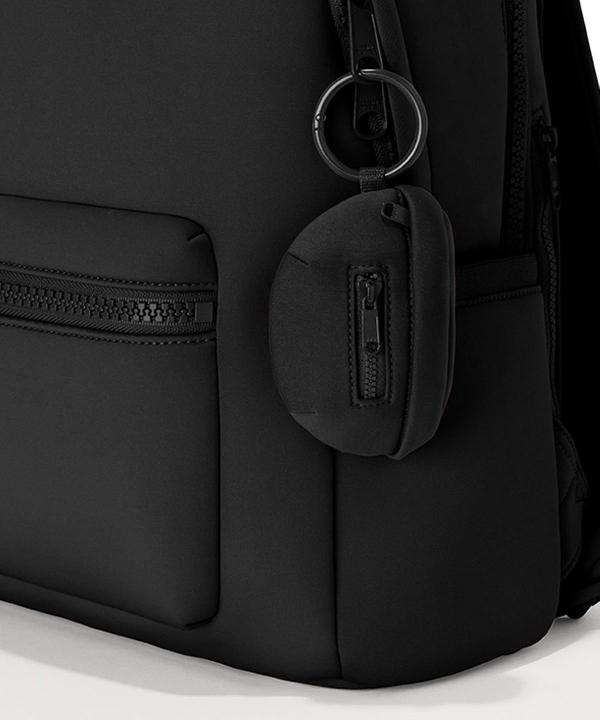 Dagne Dover Ace Keychain in black clipped onto a backpack. hover
