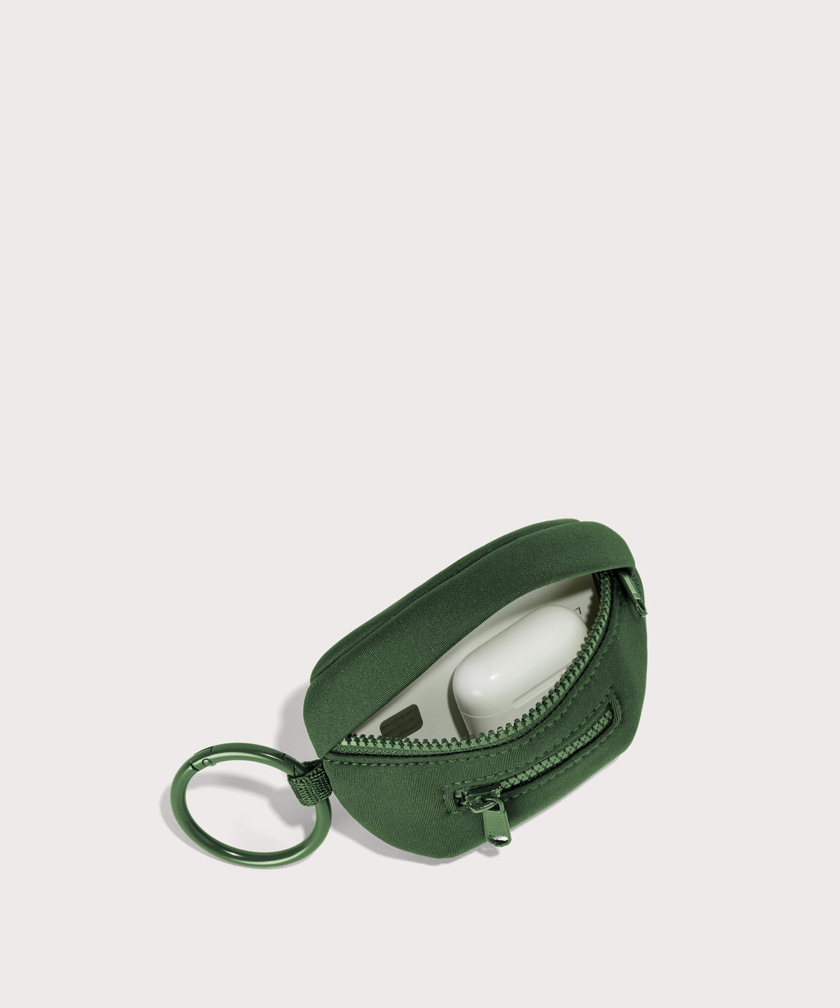 Dagne Dover Ace Keychain in a rich, classic forest green unzipped, showing interior.
