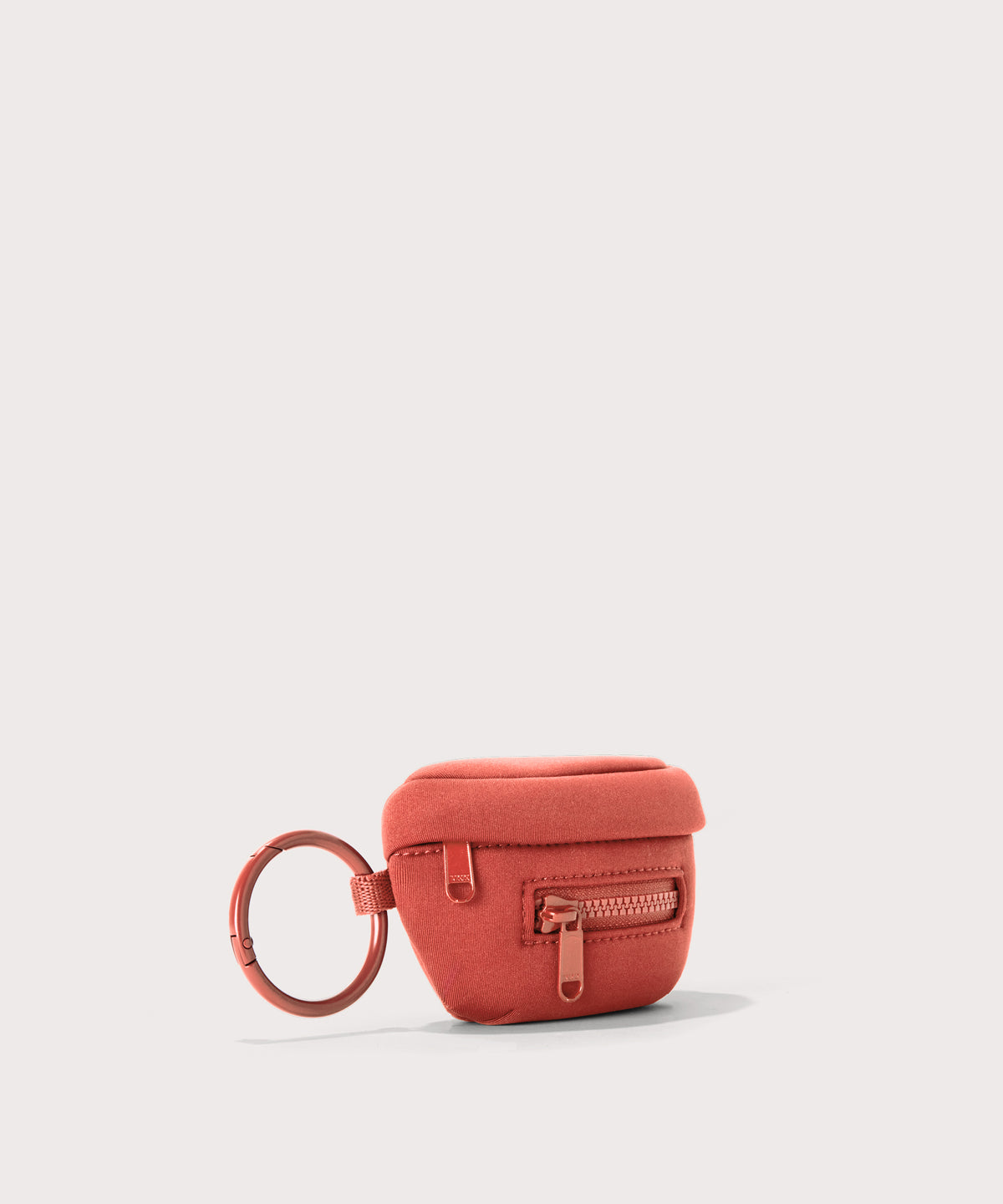 Dagne Dover Ace Keychain in a poppy, vintage wash red seen from an angle.
