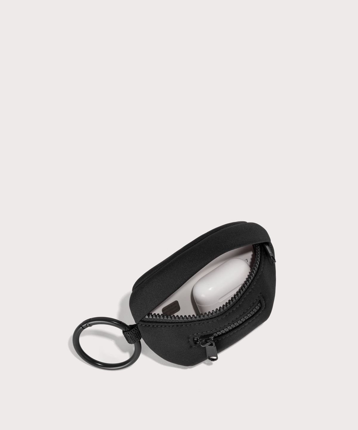 Dagne Dover Ace Keychain in black unzipped, showing interior.
