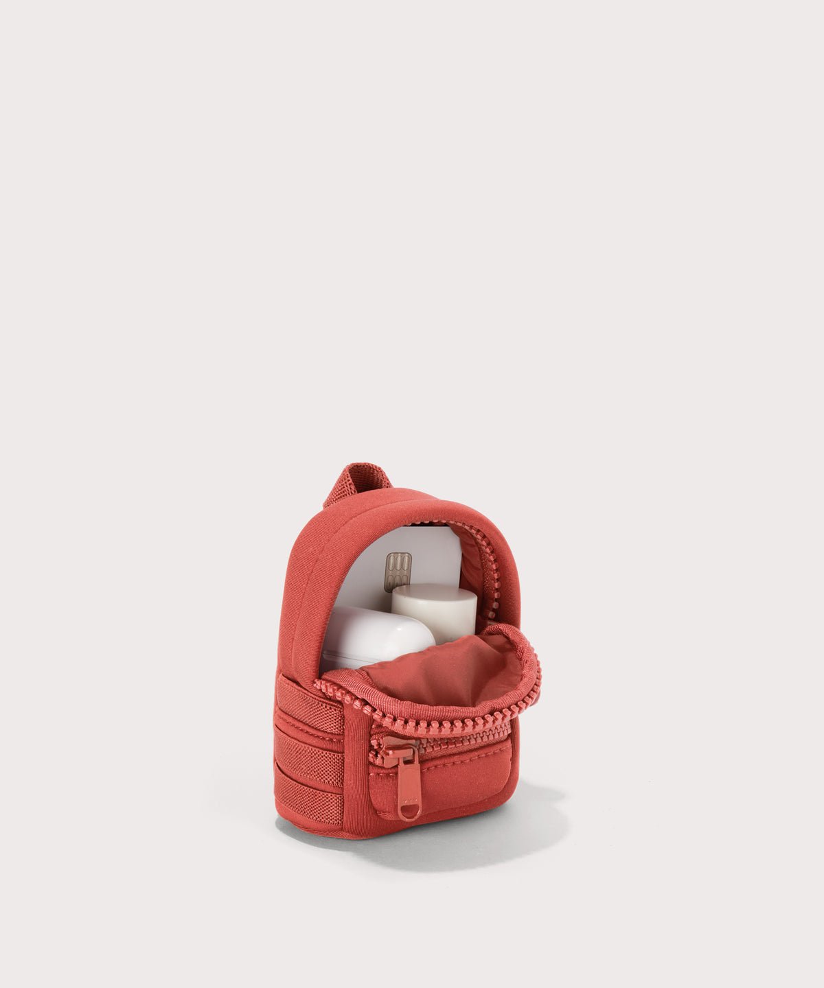 Dagne Dover Dakota Keychain in  a poppy, vintage wash red unzipped, showing interior.
