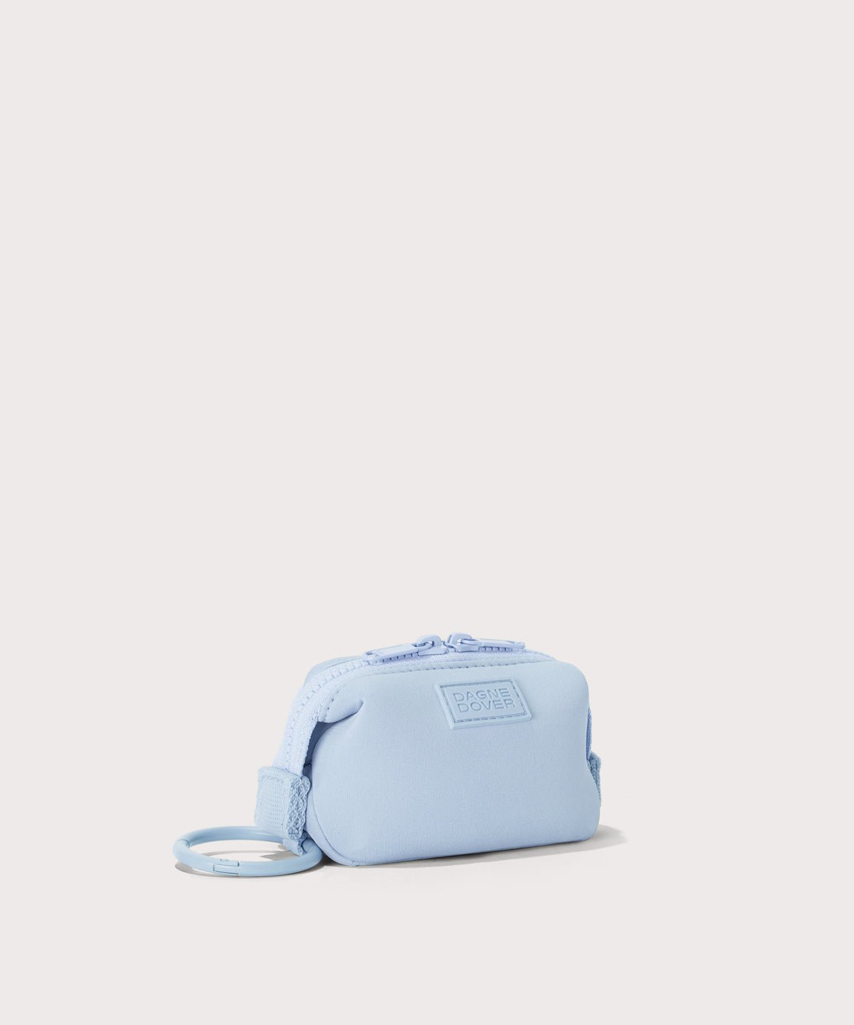 Dagne Dover Hunter Keychain in an airy, lighter sky blue seen from an angle.
