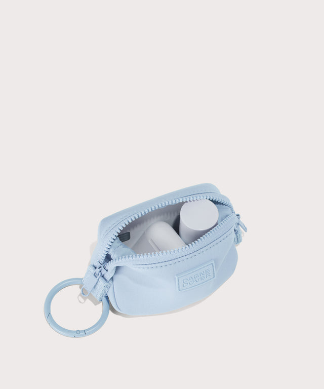 Dagne Dover Hunter Keychain in an airy, lighter sky blue unzipped, showing interior.
