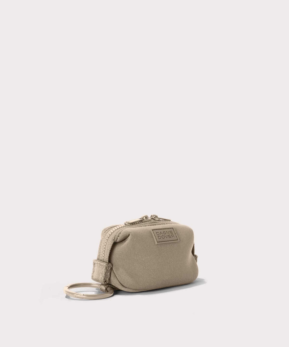 Dagne Dover Hunter Keychain in a medium-dark, creamy tan seen from an angle.
