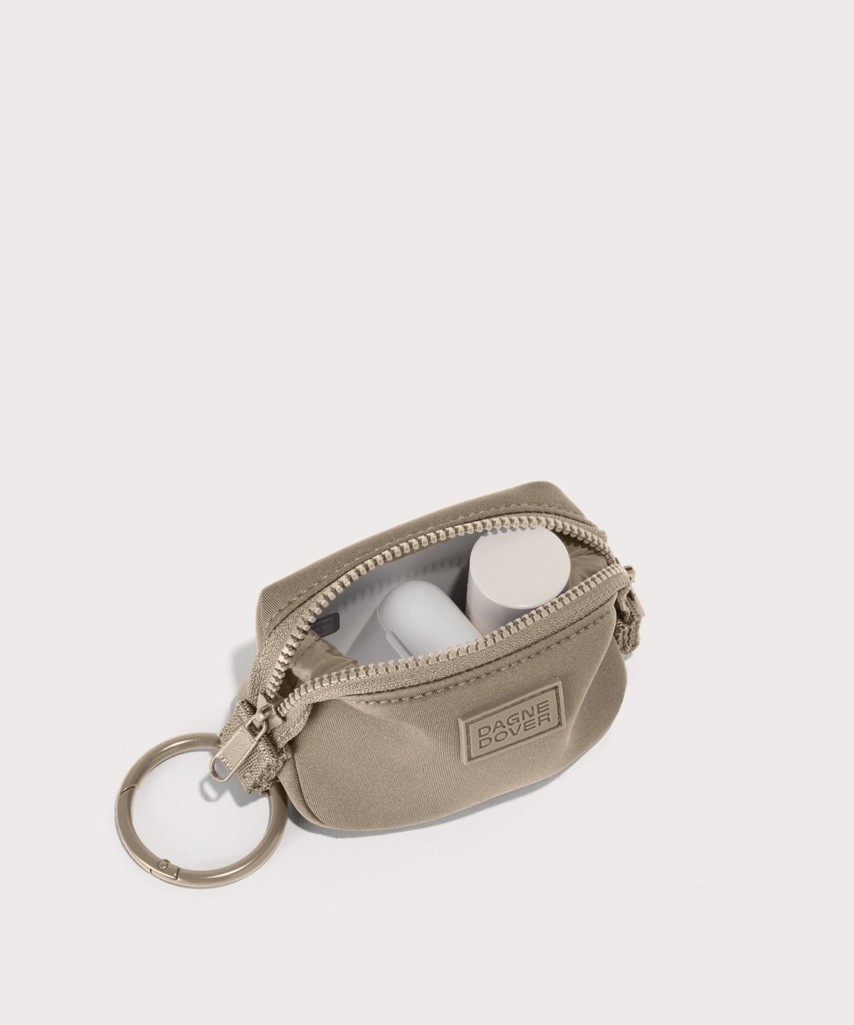 Dagne Dover Hunter Keychain in a medium-dark, creamy tan unzipped, showing interior.
