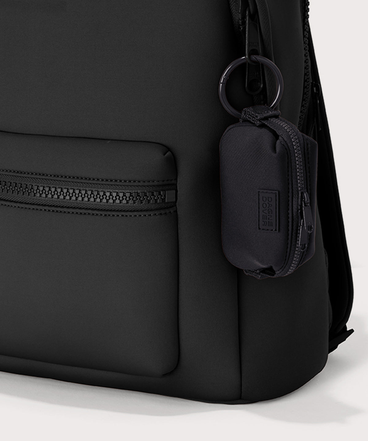 Dagne Dover Hunter Keychain in black clipped onto a backpack. 
