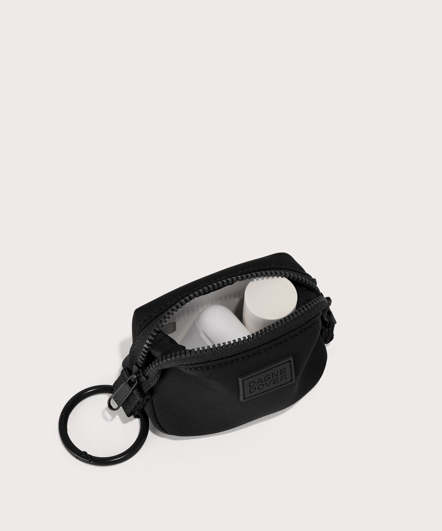 Dagne Dover Hunter Keychain in black unzipped, showing interior.
