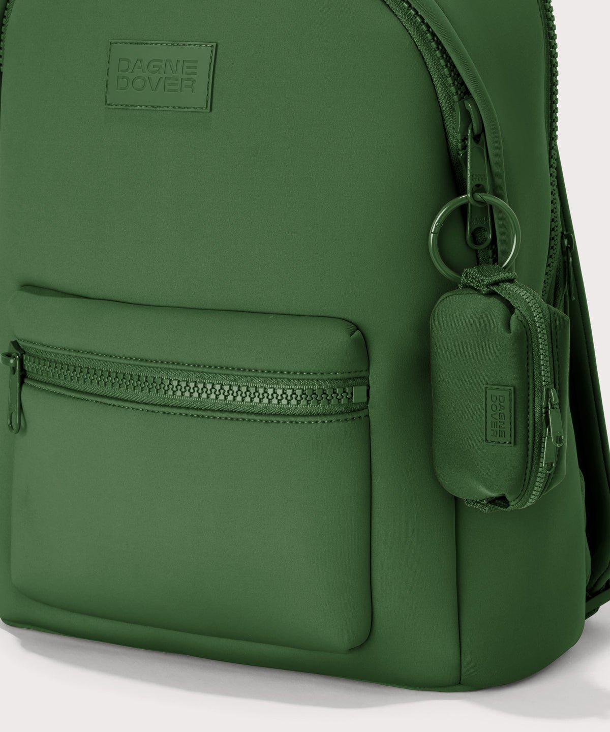 Dagne Dover Hunter Keychain in a rich, classic forest green clipped onto a backpack. 