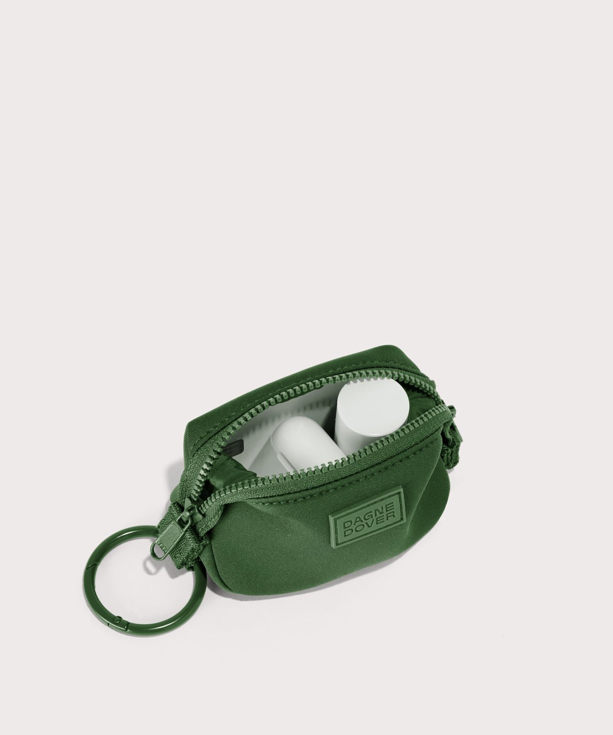 Dagne Dover Hunter Keychain in a rich, classic forest green unzipped, showing interior.
