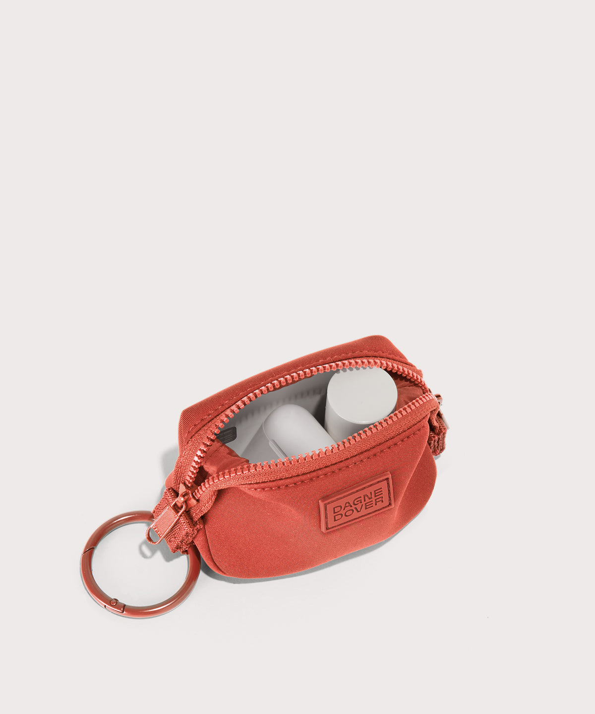 Dagne Dover Hunter Keychain in a poppy, vintage wash red unzipped, showing interior.
