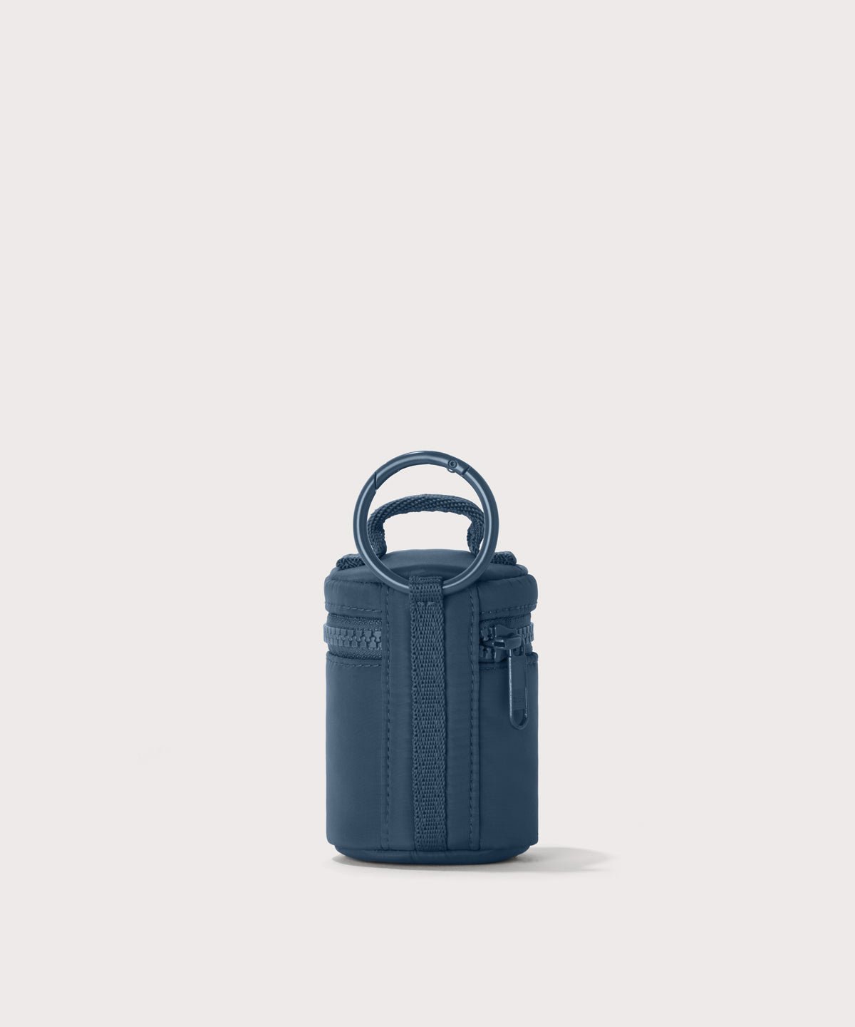 Dagne Dover Mila Keychain in a medium grey-blue with a touch of turquoise seen from the back.
