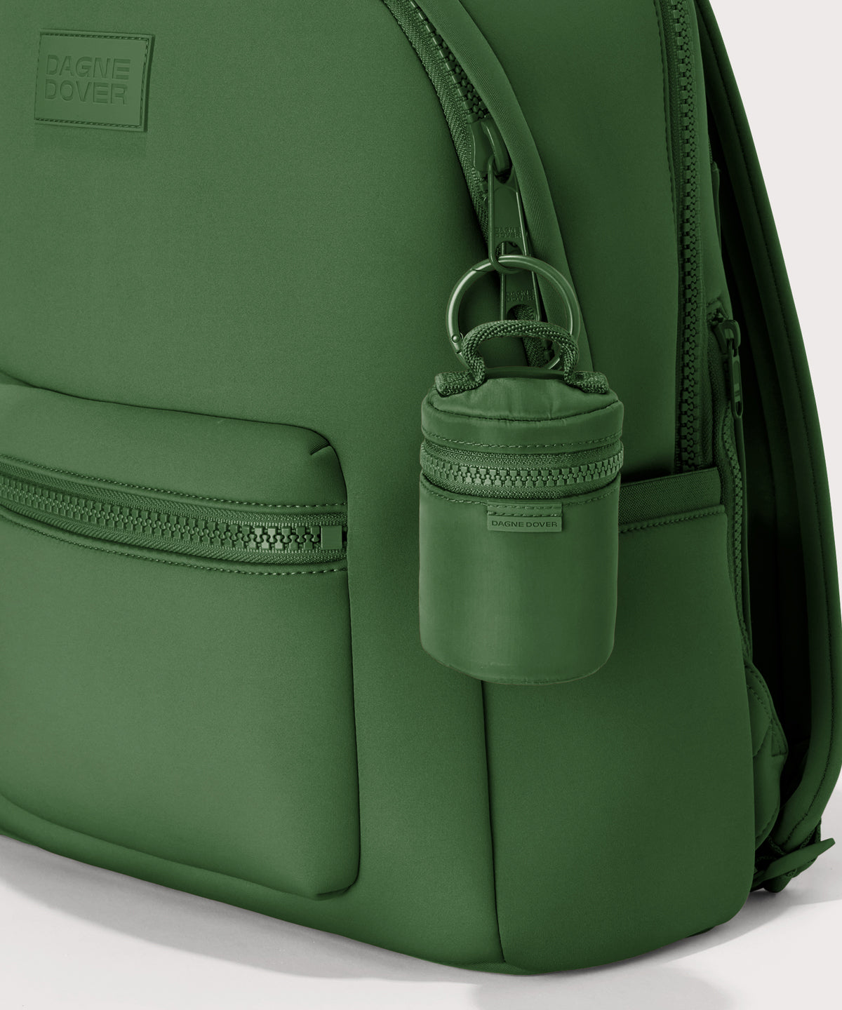 Dagne Dover Mila Keychain in a a rich, classic forest green seen on a backpack.
