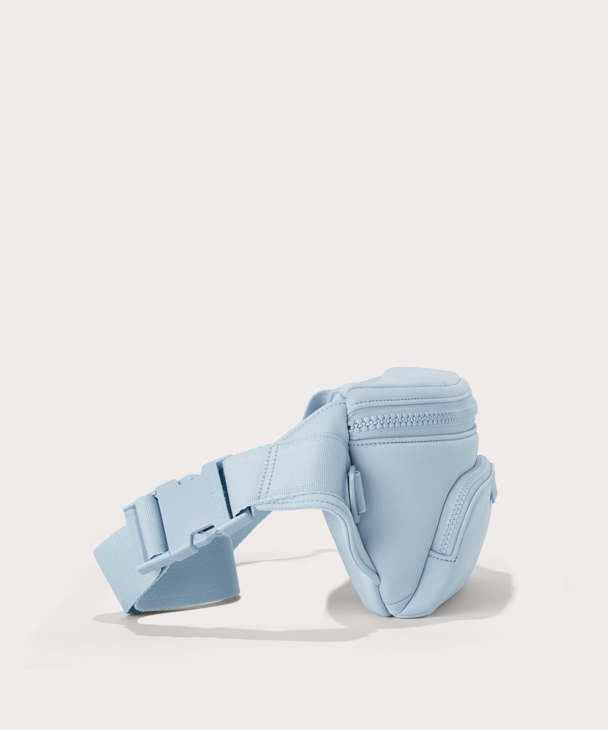 Dagne Dover jax large fanny pack in an airy, lighter sky blue seen from an angle.
