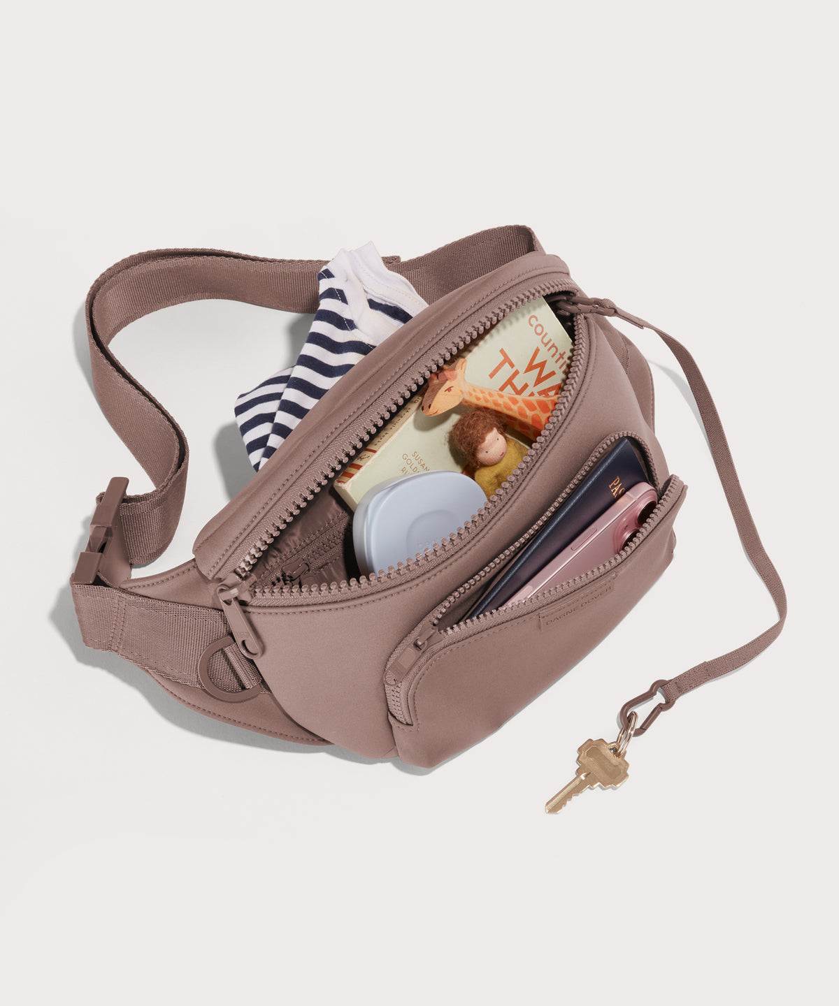 Dagne Dover jax large Fanny Pack in pink unzipped, exposing the interior pockets.