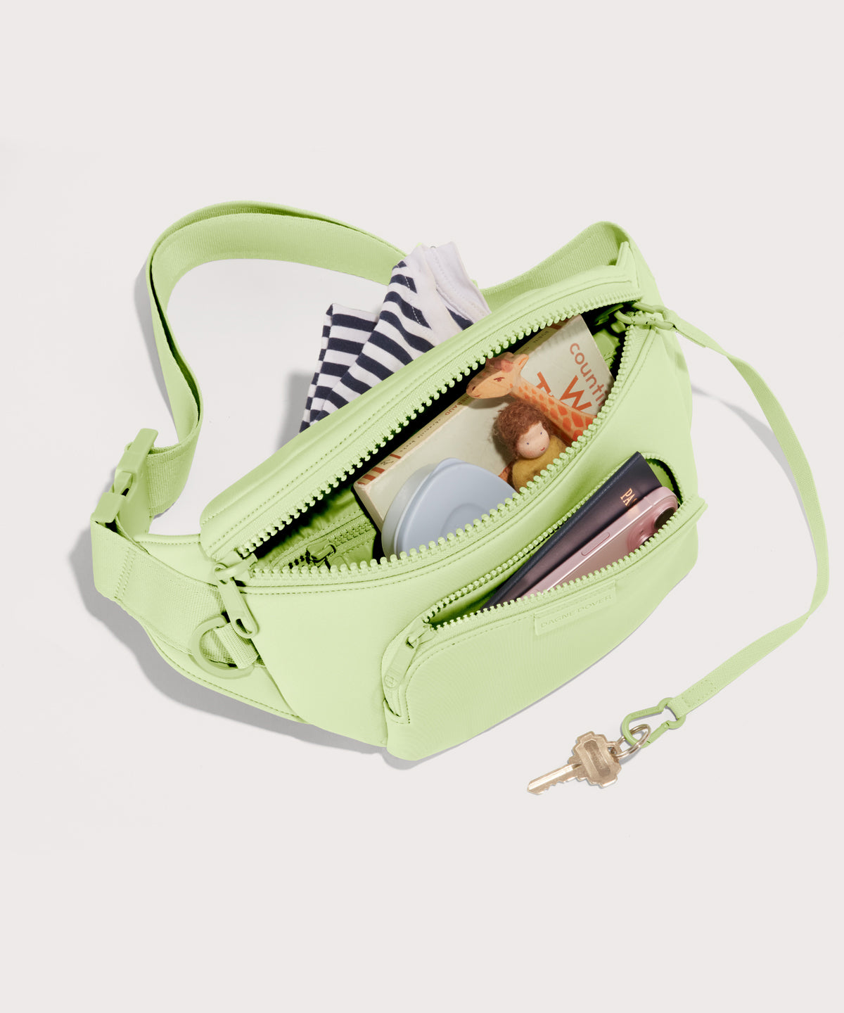Dagne Dover jax large Fanny Pack in matcha unzipped, exposing the interior pockets.