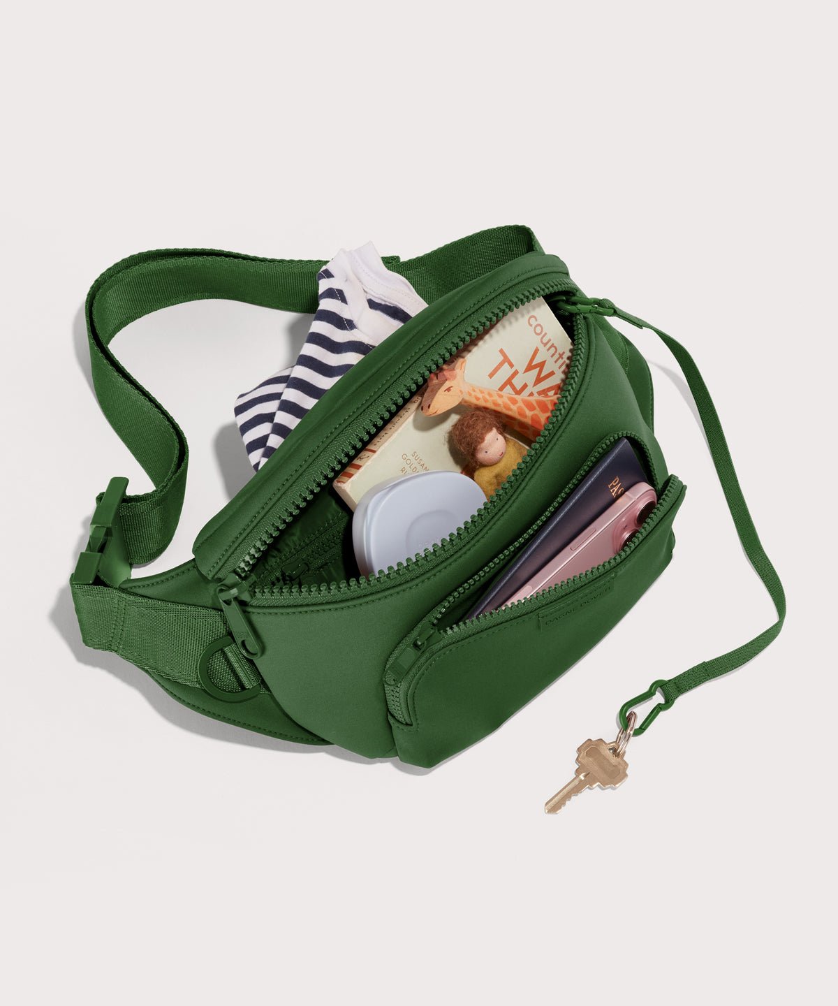 Dagne Dover jax large Fanny Pack in  a rich, classic forest green unzipped, exposing the interior pockets.