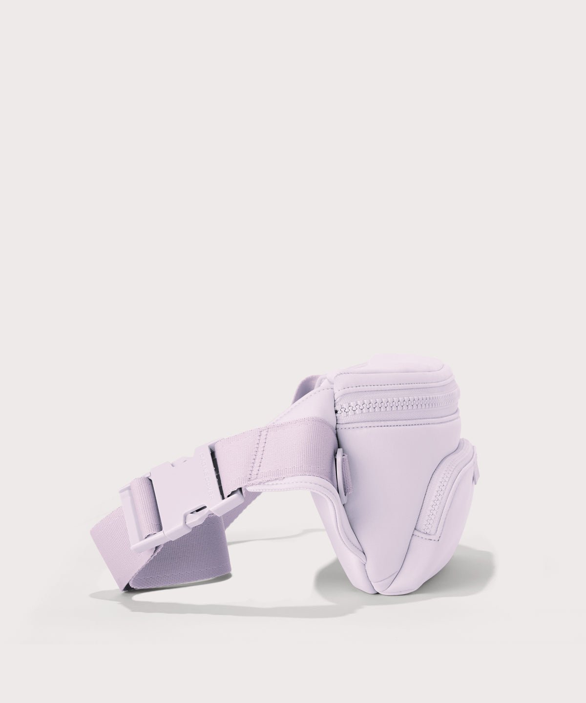 Dagne Dover jax large fanny pack in a soft purple with grey undertones seen from an angle.
