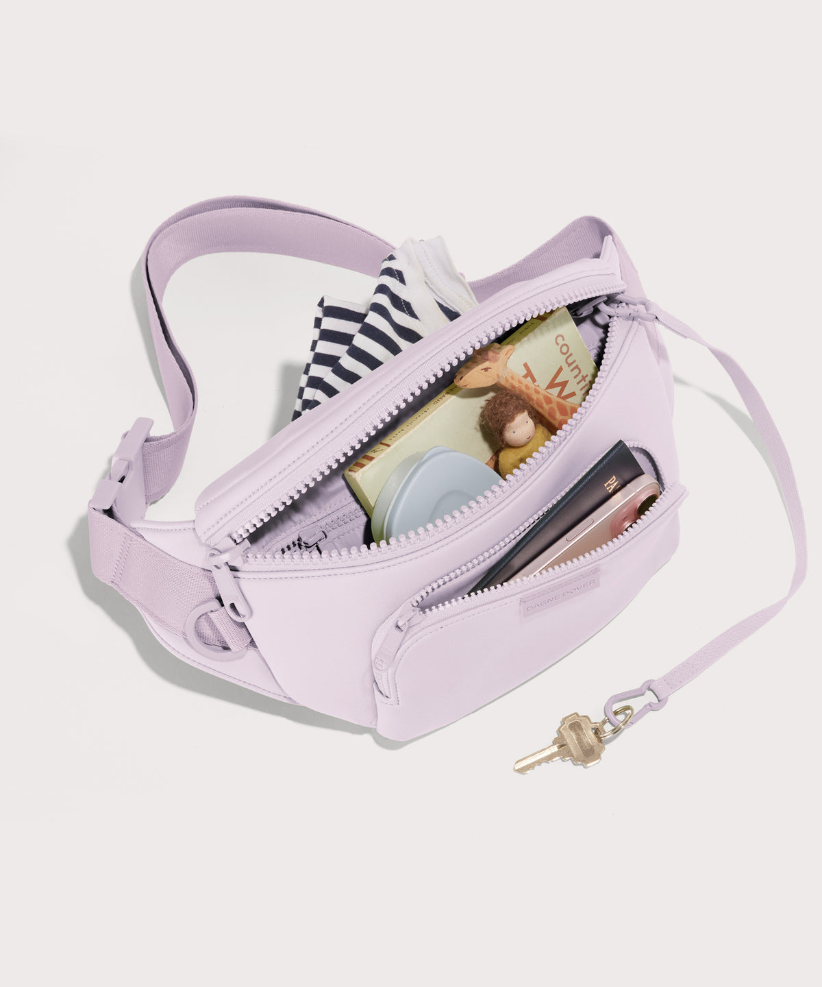 Dagne Dover jax large Fanny Pack in a soft purple with grey undertones unzipped, exposing the interior pockets.