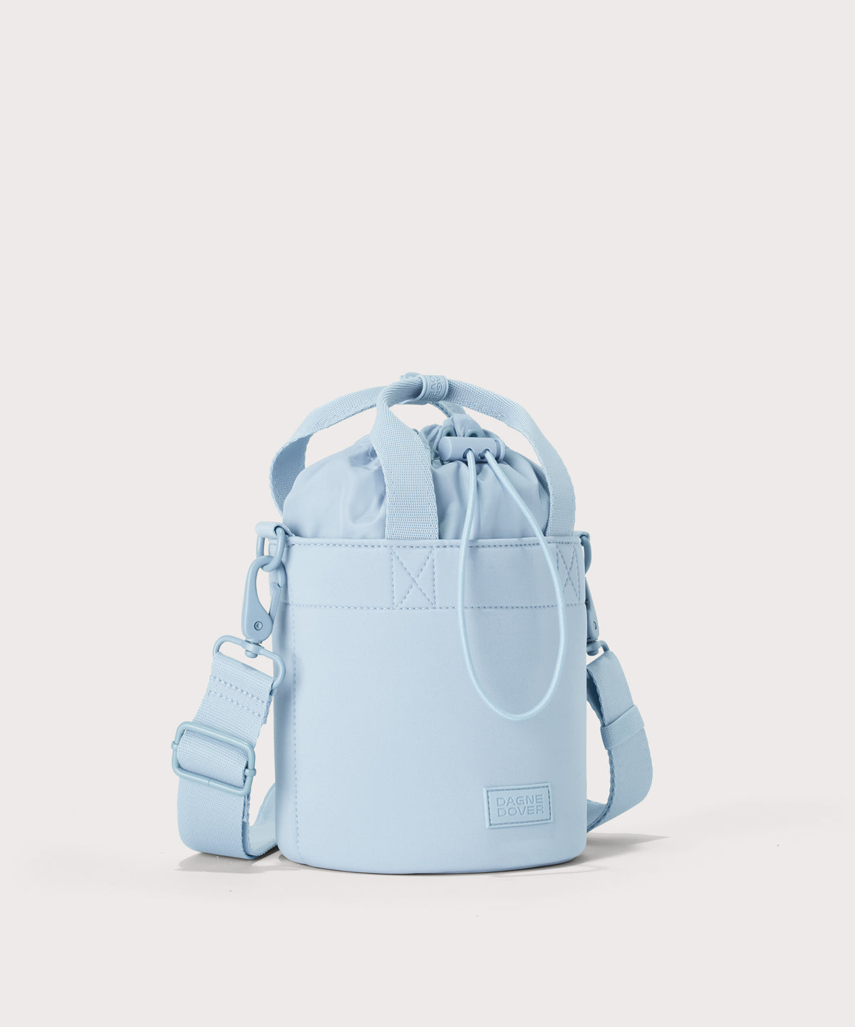 Dagne Dover Nico Bucket Bag in an airy, lighter sky blue, side angle.
