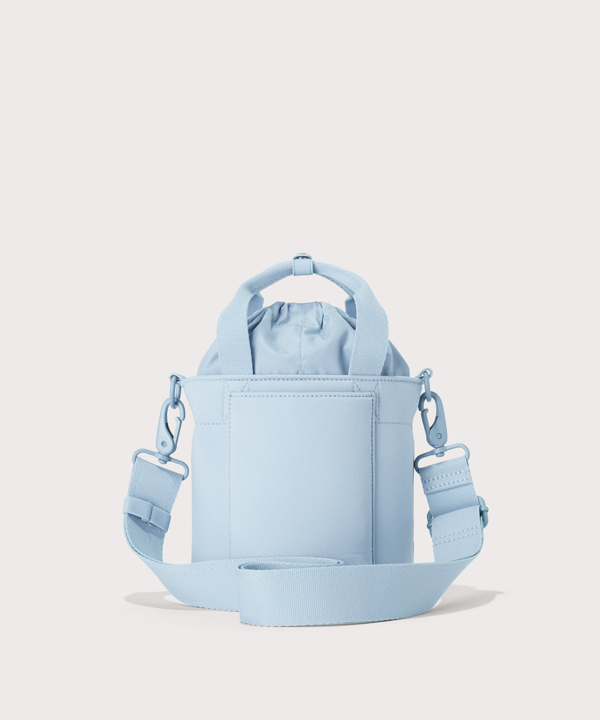 Dagne Dover Nico Bucket Bag in an airy, lighter sky blue, back angle.
