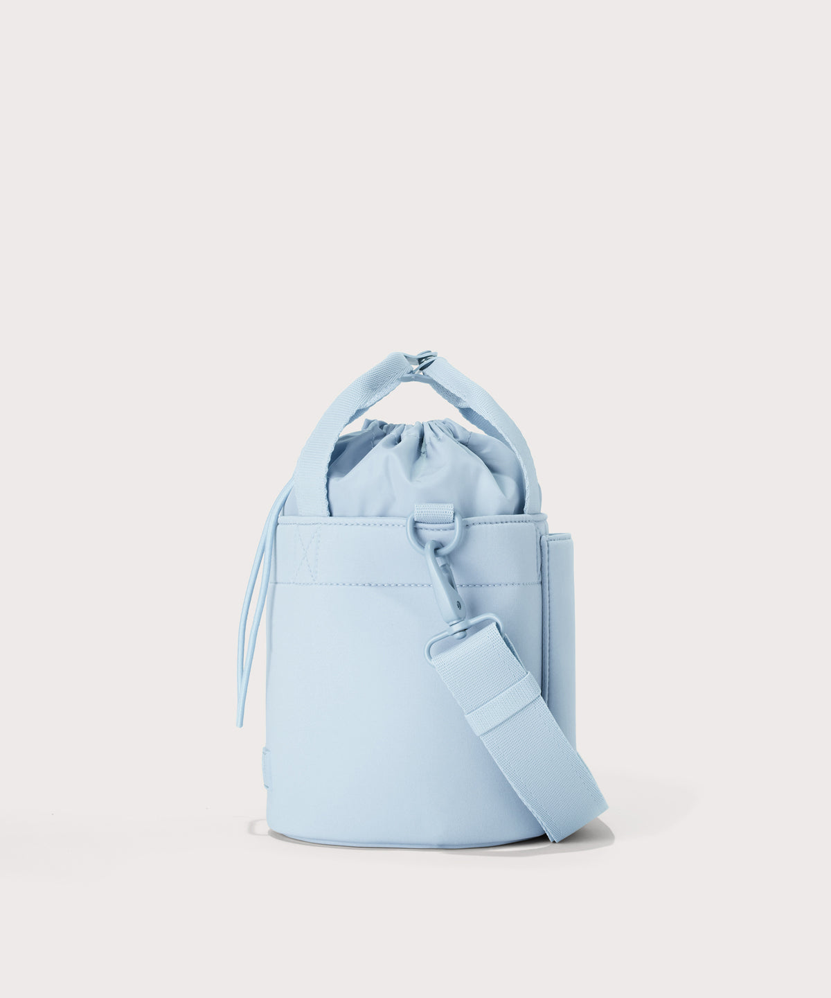 Dagne Dover Nico Bucket Bag in an airy, lighter sky blue, side angle.

