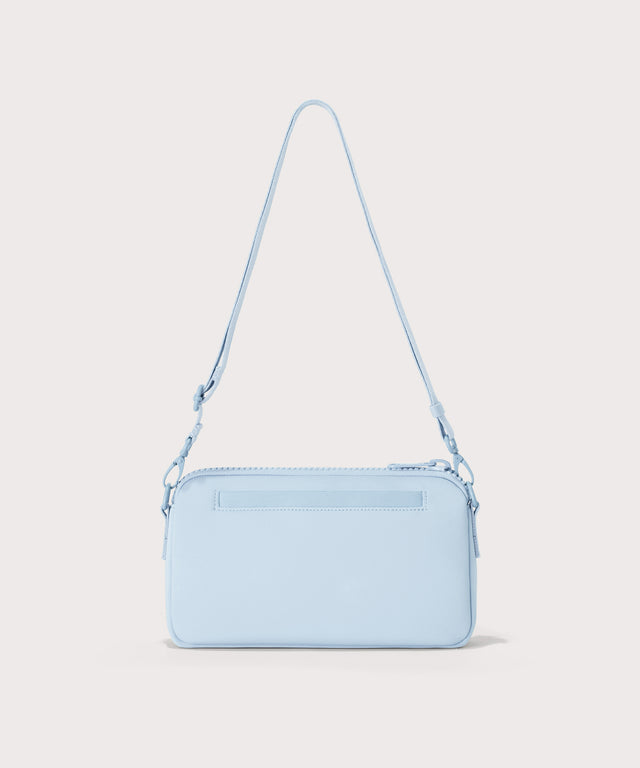 Dagne Dover Nora Shoulder Bag in an airy, lighter sky blue, back angle.
