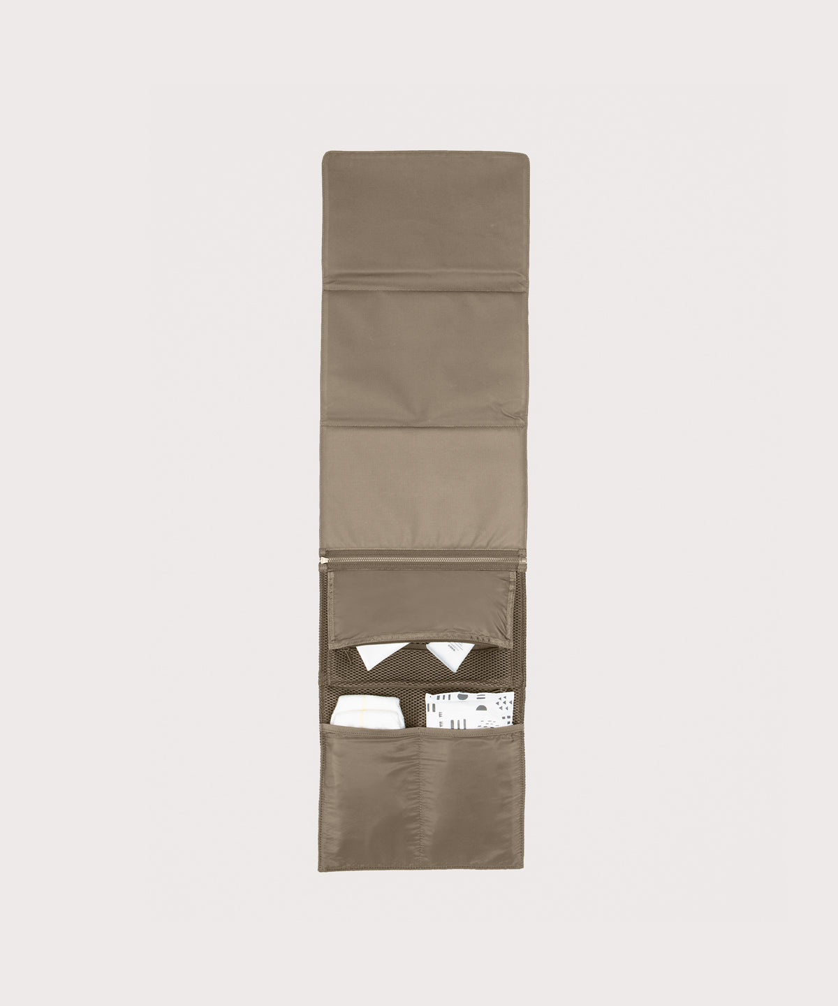 Dagne Dover Joey Changing Kit in khaki unfolded, revealing the interior zipper pocket and interior slip pockets.
