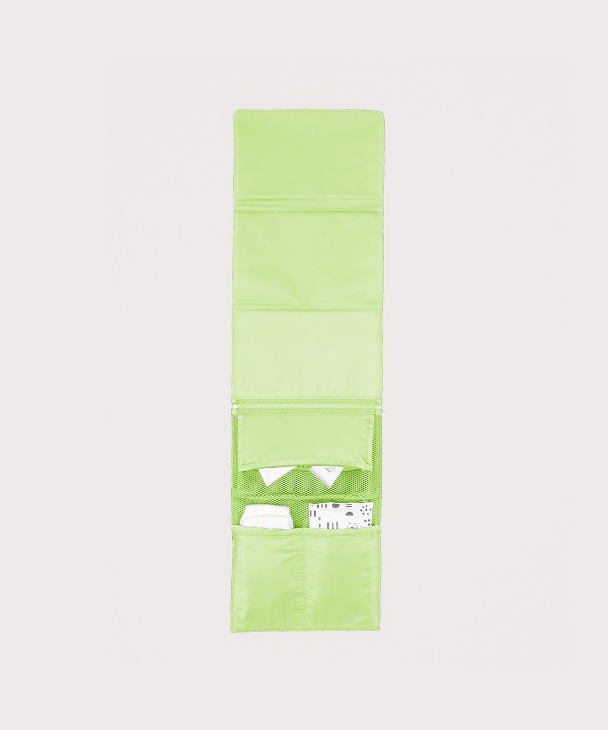 Dagne Dover Joey Changing Kit in matcha unfolded, revealing the interior zipper pocket and interior slip pockets.
