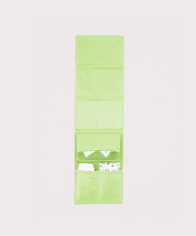 Dagne Dover Joey Changing Kit in matcha unfolded, revealing the interior zipper pocket and interior slip pockets.
