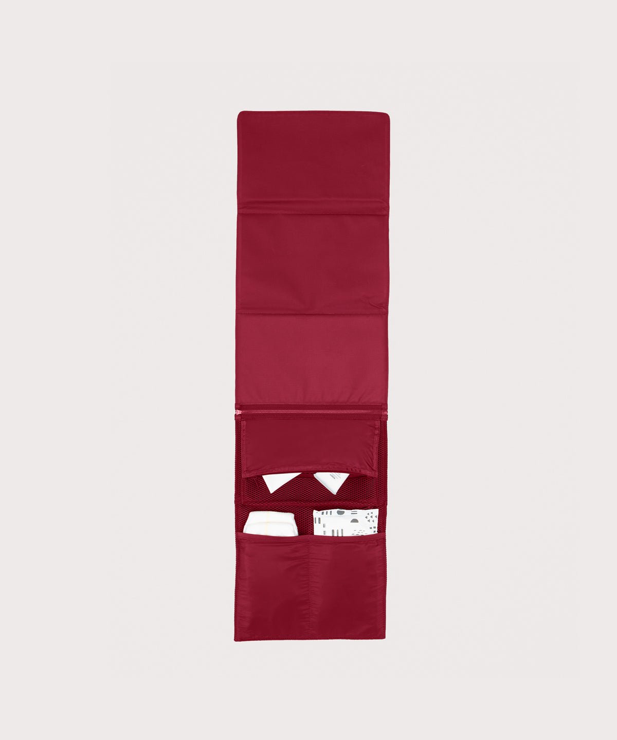Dagne Dover Joey Changing Kit in spice unfolded, revealing the interior zipper pocket and interior slip pockets.

