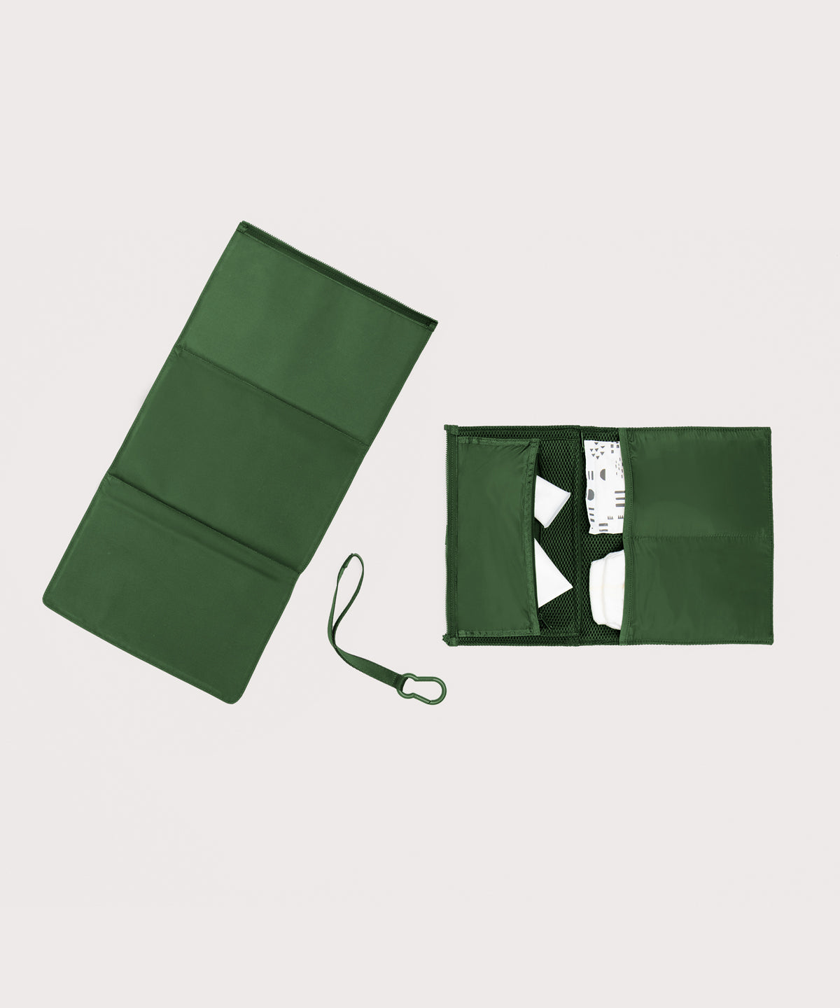 Dagne Dover Joey Changing Kit in a rich, classic forest green unfolded, revealing the detachable changing mat.
