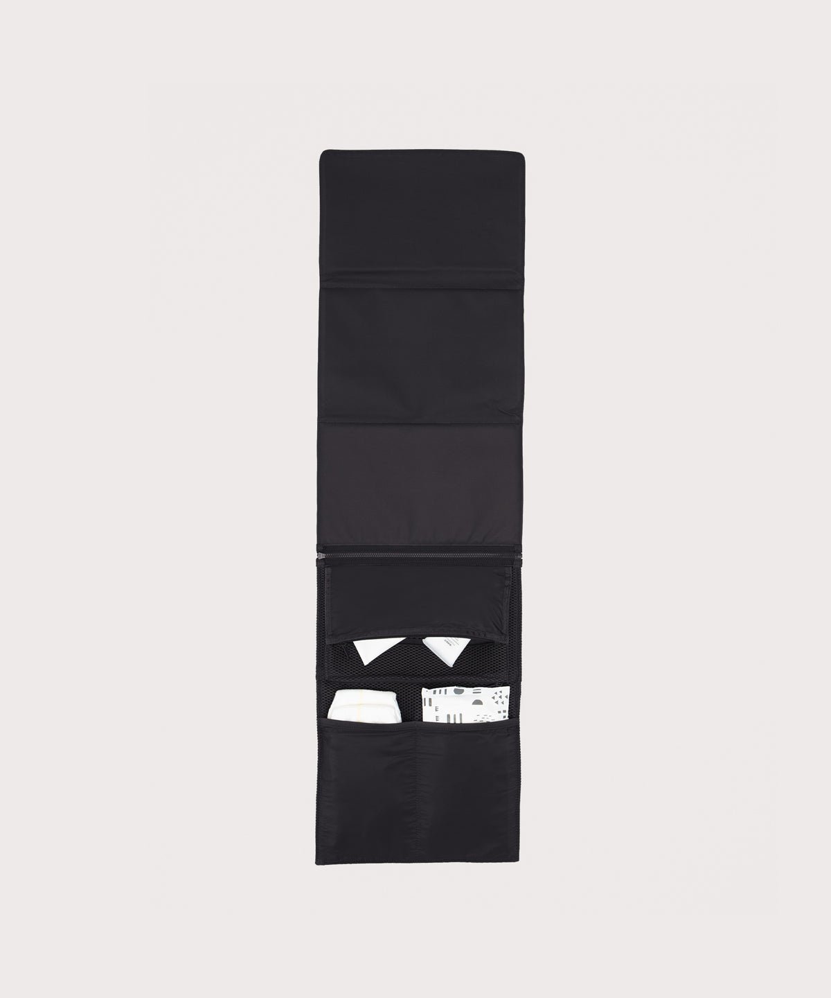 Dagne Dover Joey Changing Kit in black unfolded, revealing the detachable changing mat.
