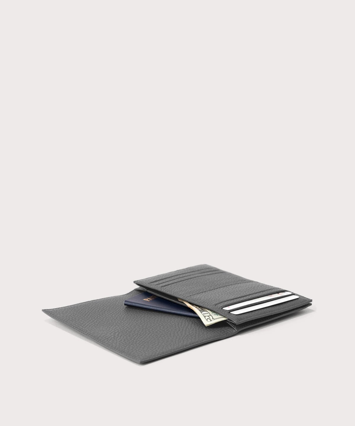 dagne-2025-Dagne Dover Accordion Travel Wallet in grey opened, revealing the internal card slots and internal gusseted card and passport slots.