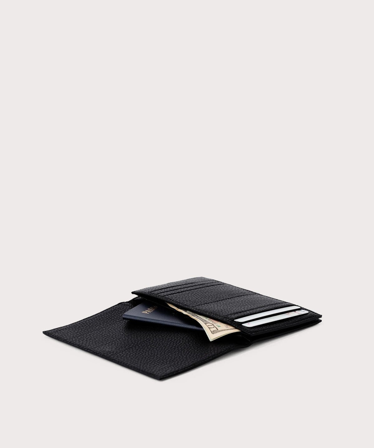 Dagne Dover Accordion Travel Wallet in black opened, revealing the internal card slots and internal gusseted card and passport slots.